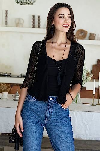 Shows the product being worn in a natural home setting to help shoppers visualize how the clothing looks when styled in everyday life.