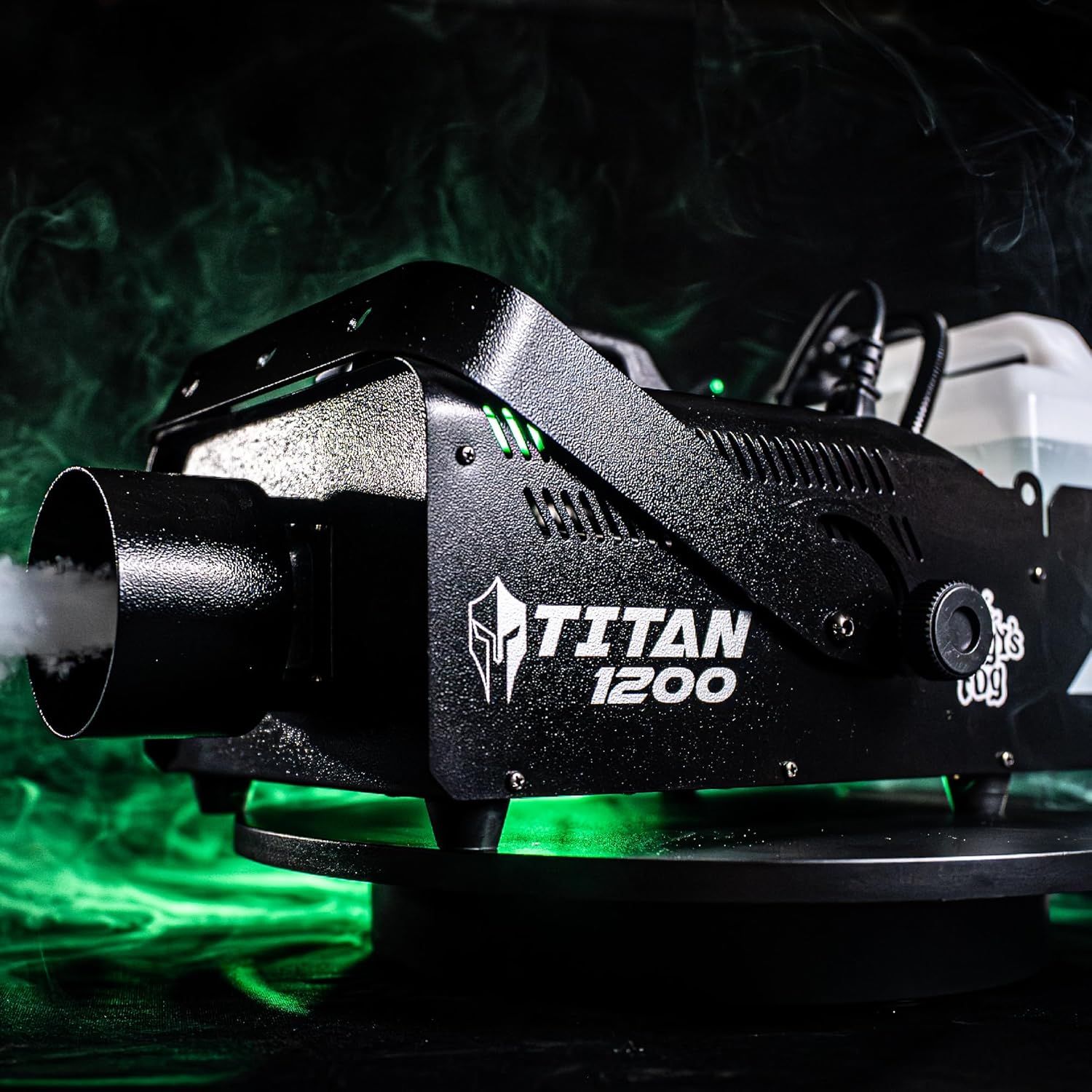 Demonstrates the product in use within a real-world atmospheric setting, showing the fog machine actively producing green-lit smoke to help shoppers visualize its performance and effect.