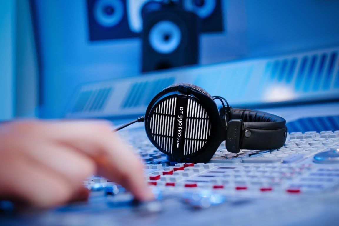 Shows the headphones in a real-world professional audio production setting to help shoppers visualize the product in use and understand its intended application.