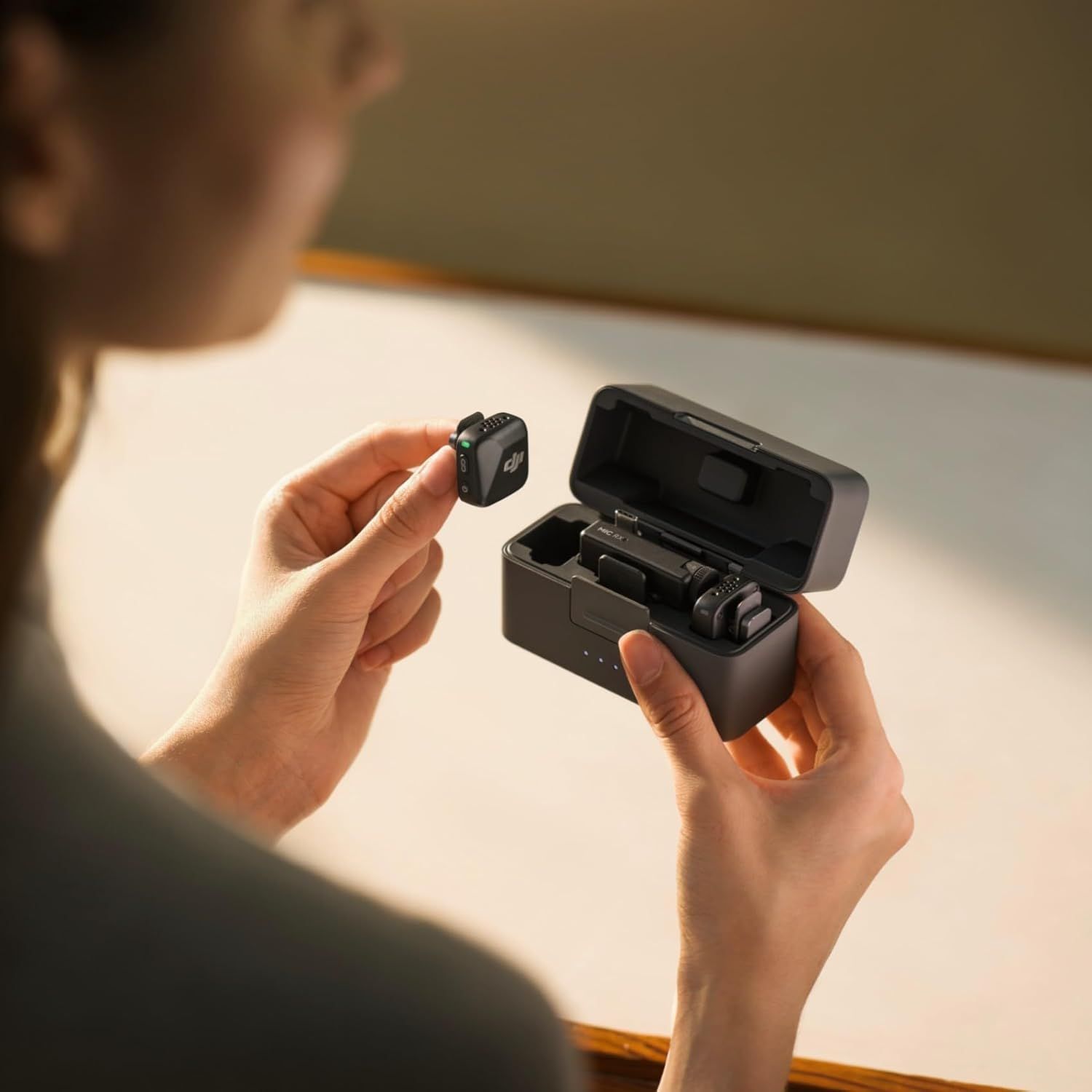 Shows the product being used in a natural setting to help shoppers visualize how they would interact with the wireless earbuds and charging case in everyday life.