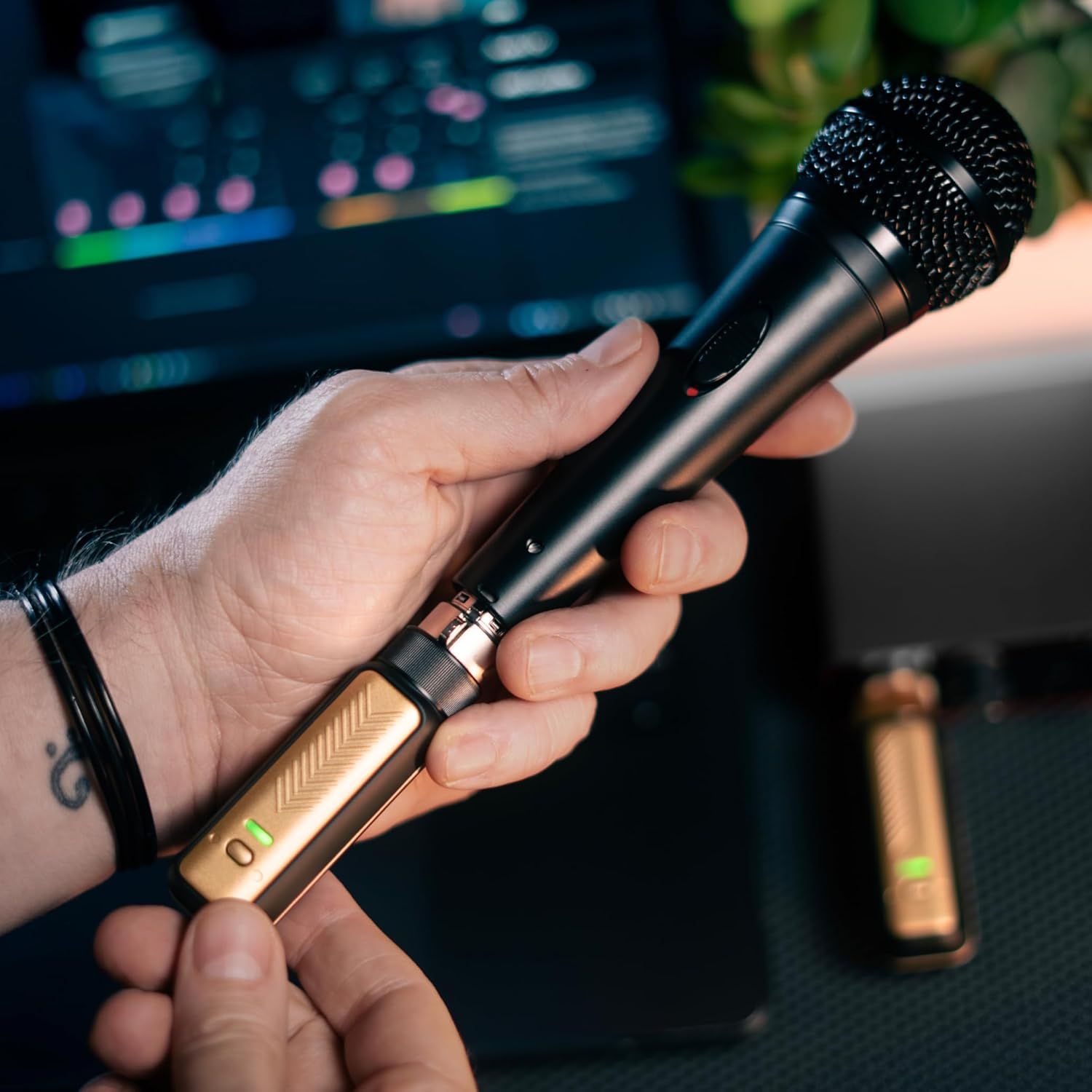 Shows the wireless microphone being held and used in a real-world recording or performance setting to help shoppers visualize how the product fits into their own use case.