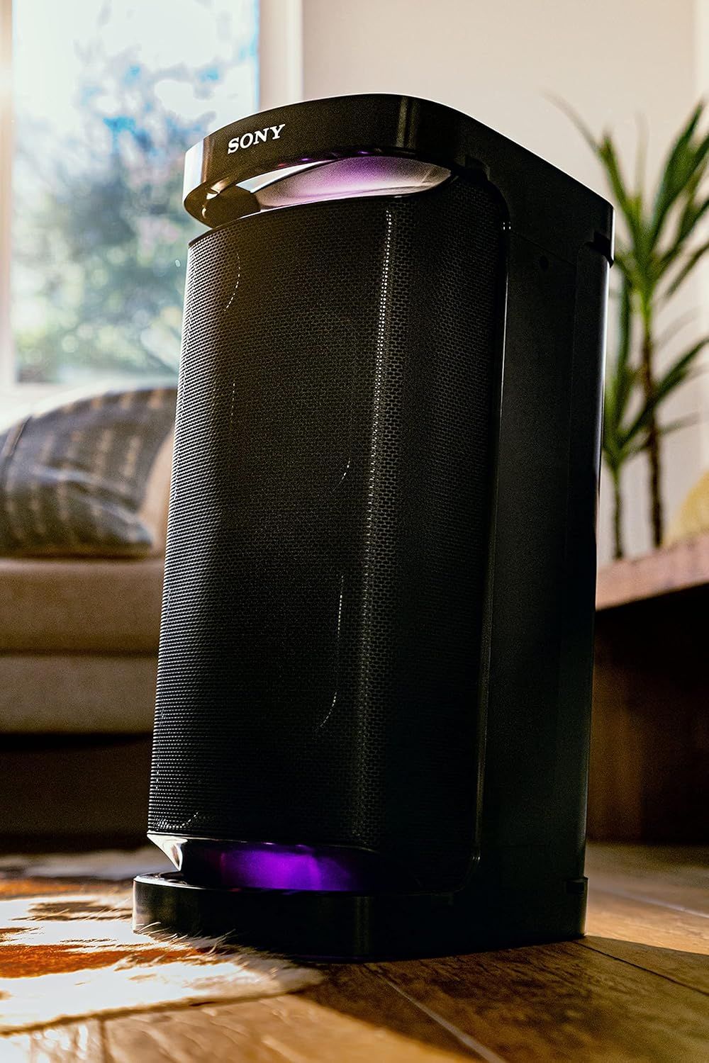 Shows the Sony speaker in a real-world living room setting to help shoppers visualize how the product fits into their home decor and lifestyle.