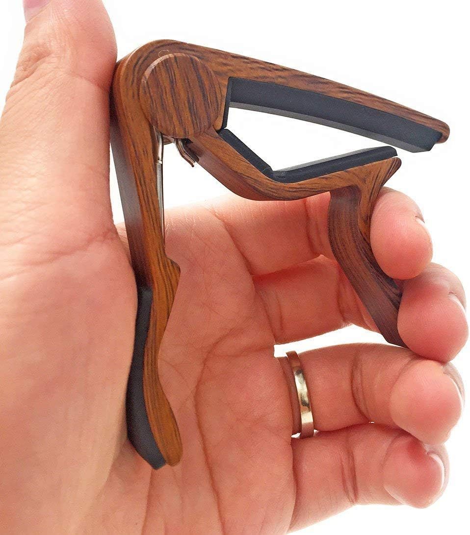Showcases the high-quality wood grain finish and craftsmanship of the guitar capo to communicate premium materials and aesthetic appeal.
