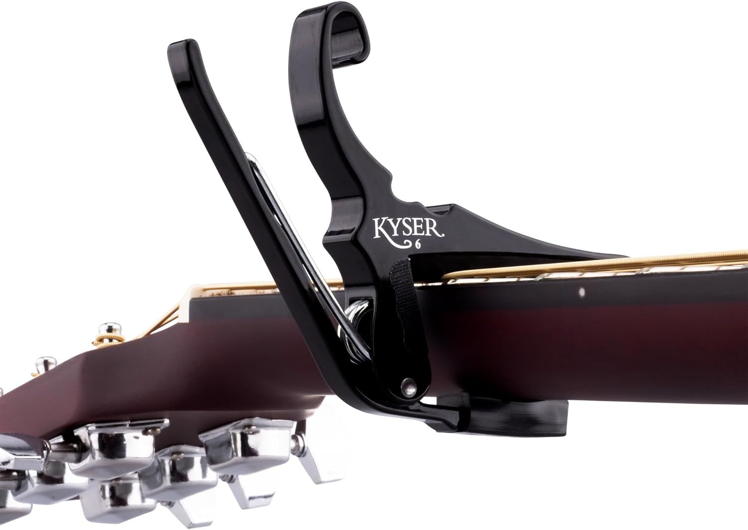 Shows the product attached to a guitar in a real-world context to help shoppers visualize how the capo looks and functions on an actual instrument.