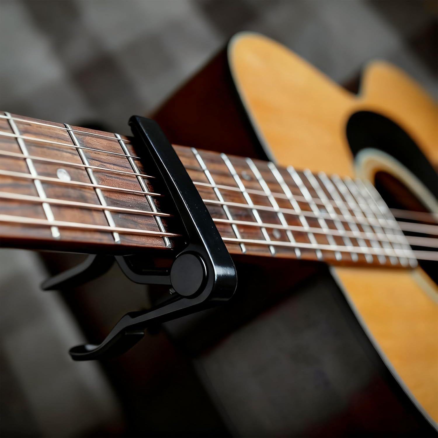 Shows the product (guitar capo) in a real-world context on an acoustic guitar, helping shoppers visualize how it looks and fits when in use.
