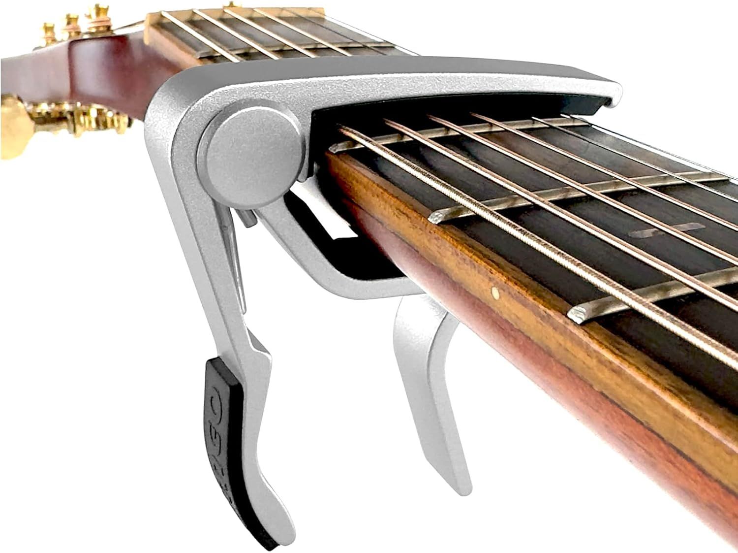 Showcases the guitar capo's sleek design and how it clamps onto the guitar neck, reassuring shoppers of its functionality and quality construction.