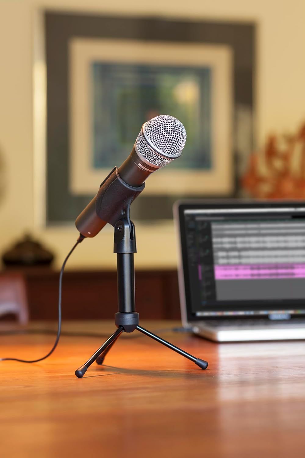 Shows the microphone in a real-world home or office environment to help shoppers visualize how the product fits into their workspace or daily use.
