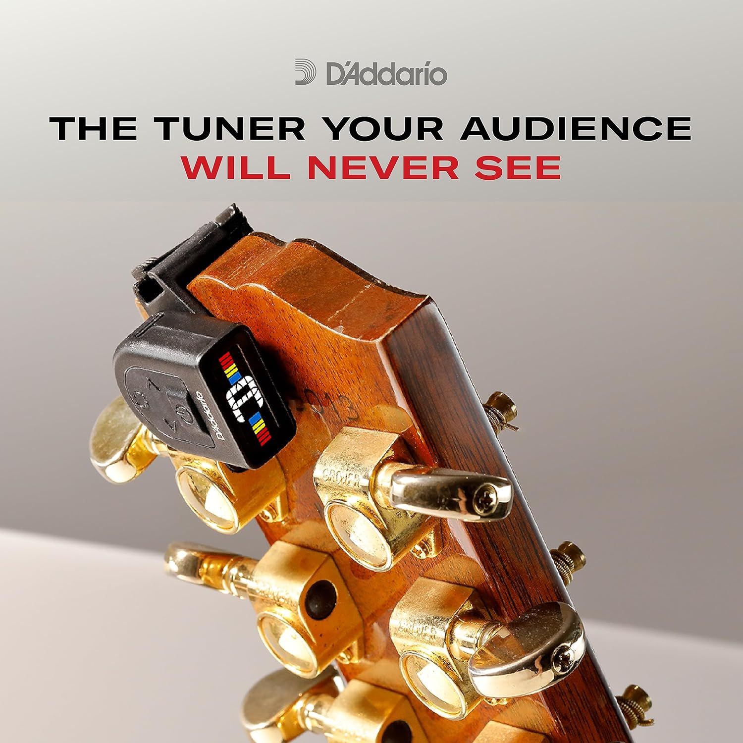 Communicates that the tuner is small and hidden from view when clipped to the guitar headstock, ensuring it won't distract the audience during performance.