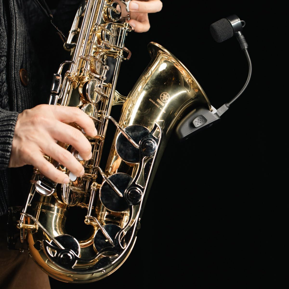 Shows the saxophone being played in a real-world context to help shoppers visualize themselves using the instrument and understand its size and handling.