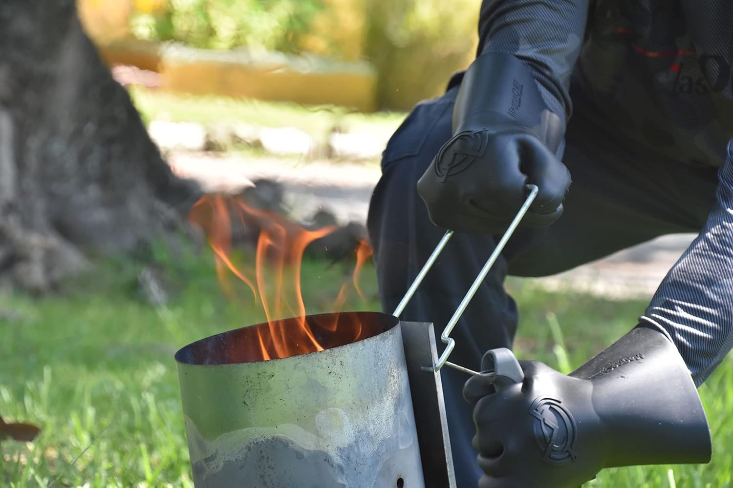 Demonstrates the gloves ability to safely handle hot objects and protect hands from fire and extreme heat during outdoor cooking or camping activities.