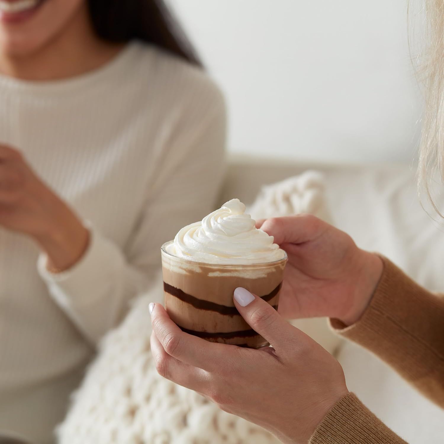 Shows the product being enjoyed in a real-world social setting to help shoppers visualize using it with friends or family in a comfortable home environment.