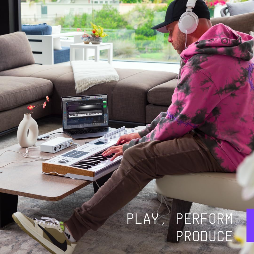 Demonstrates the product being used in a real-world home environment for music creation, showing the lifestyle context and versatility of the keyboard for creative professionals.