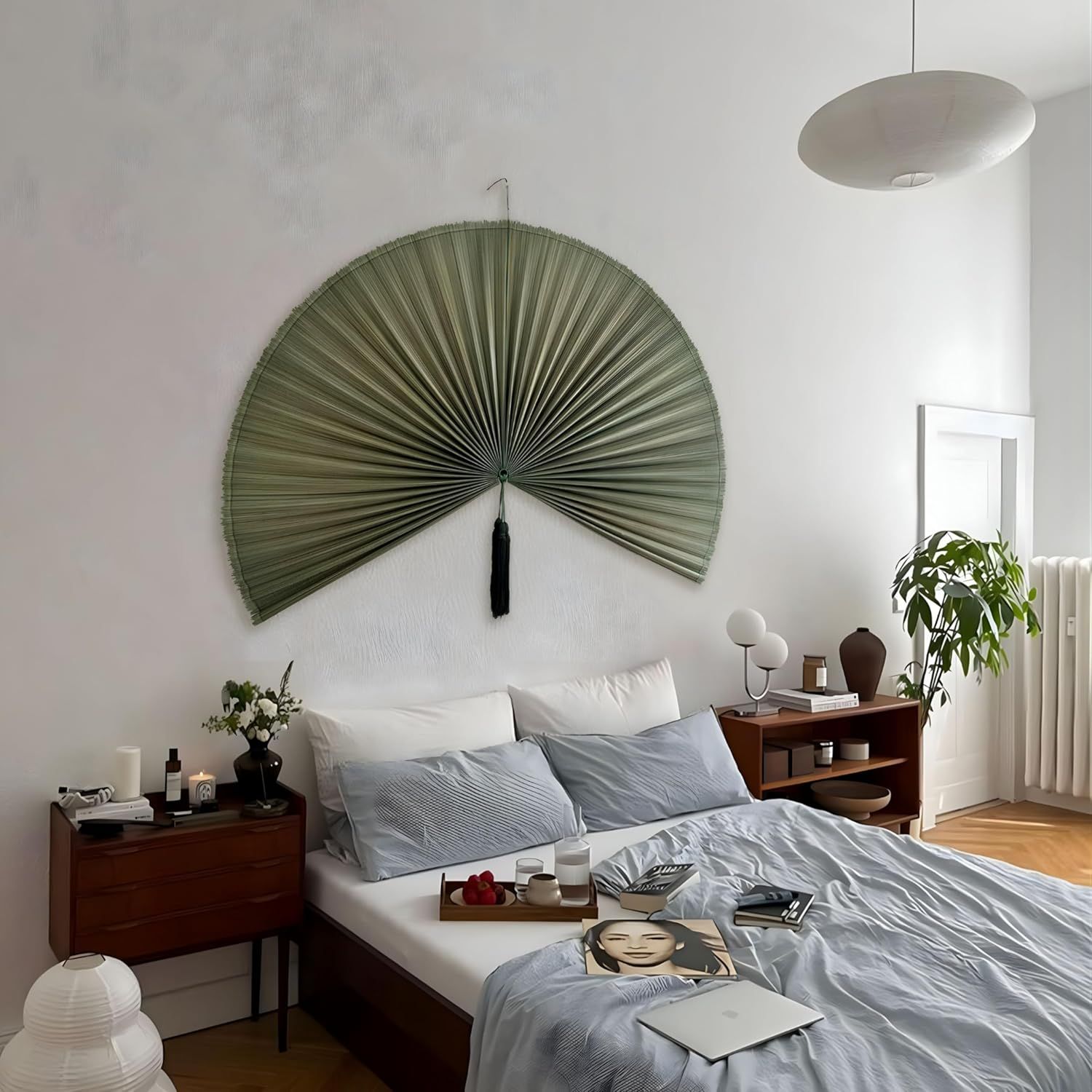 Shows the product displayed as wall decor in a real bedroom setting to help shoppers visualize how it looks in their own home.