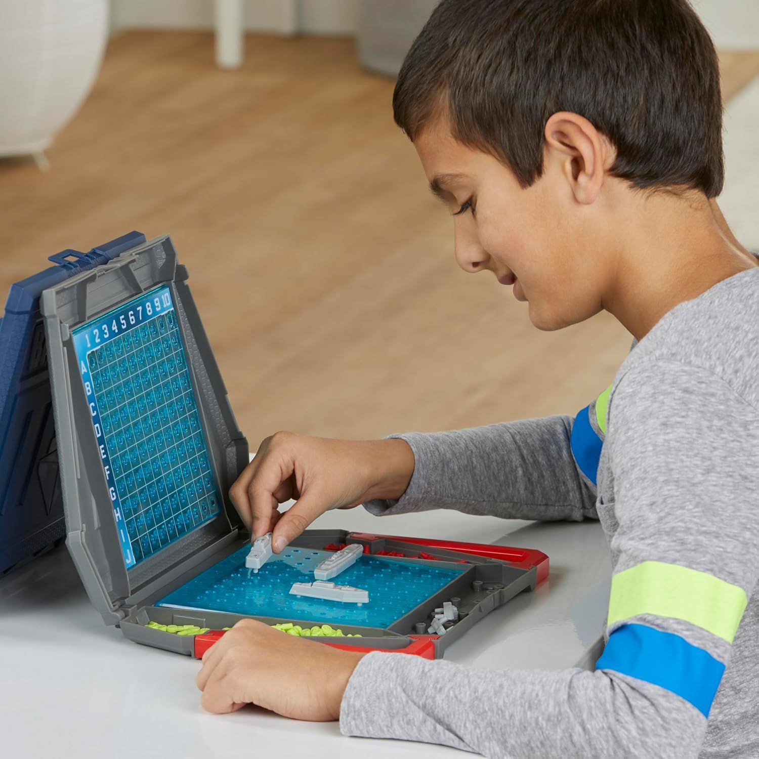 Shows the product being used by a child in a real-world home setting to help shoppers visualize how the game works and who it's for.