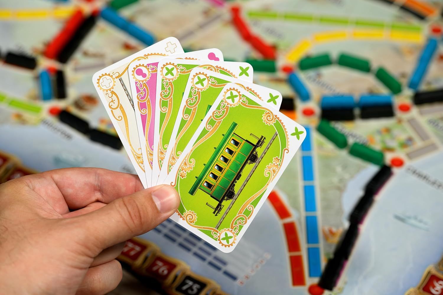 Shows the game cards included with the board game to help shoppers understand what components come in the box and the visual design of the playing cards.