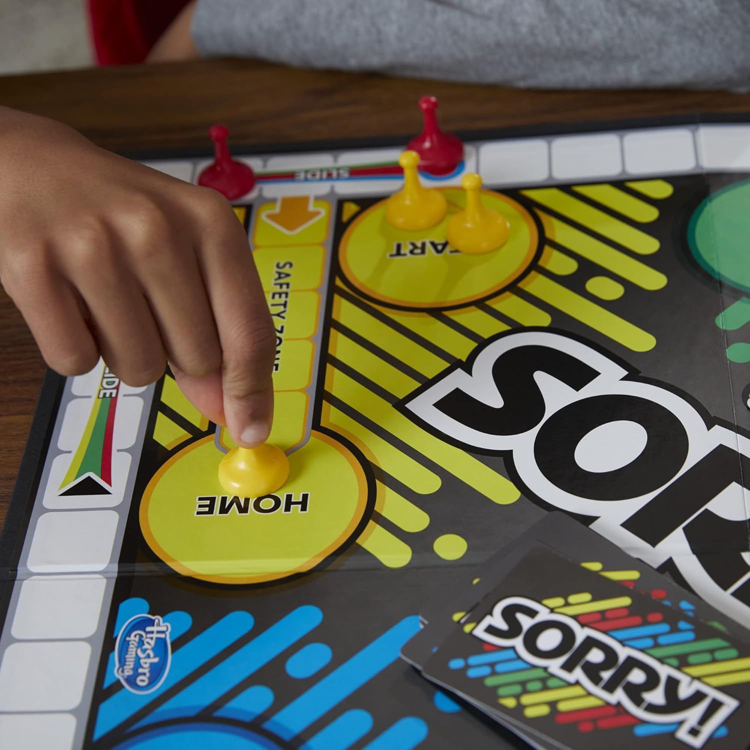 Shows the product being actively played by a child in a real-world setting to help shoppers visualize the product in use and understand its appeal for family game time.