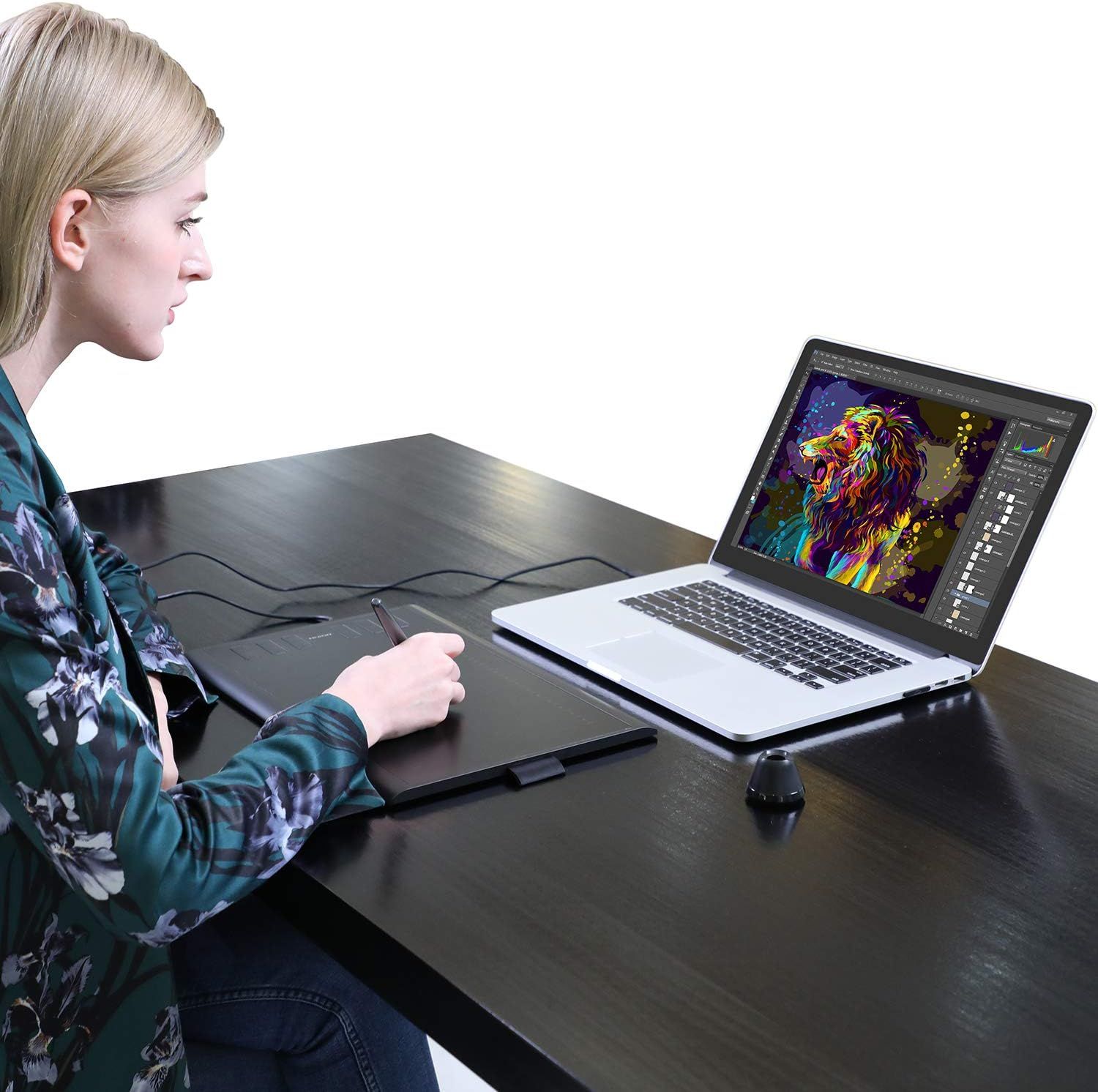 Demonstrates the product in a real-world creative professional context, showing a user working with graphic design software to communicate the product's suitability for digital artists and designers.