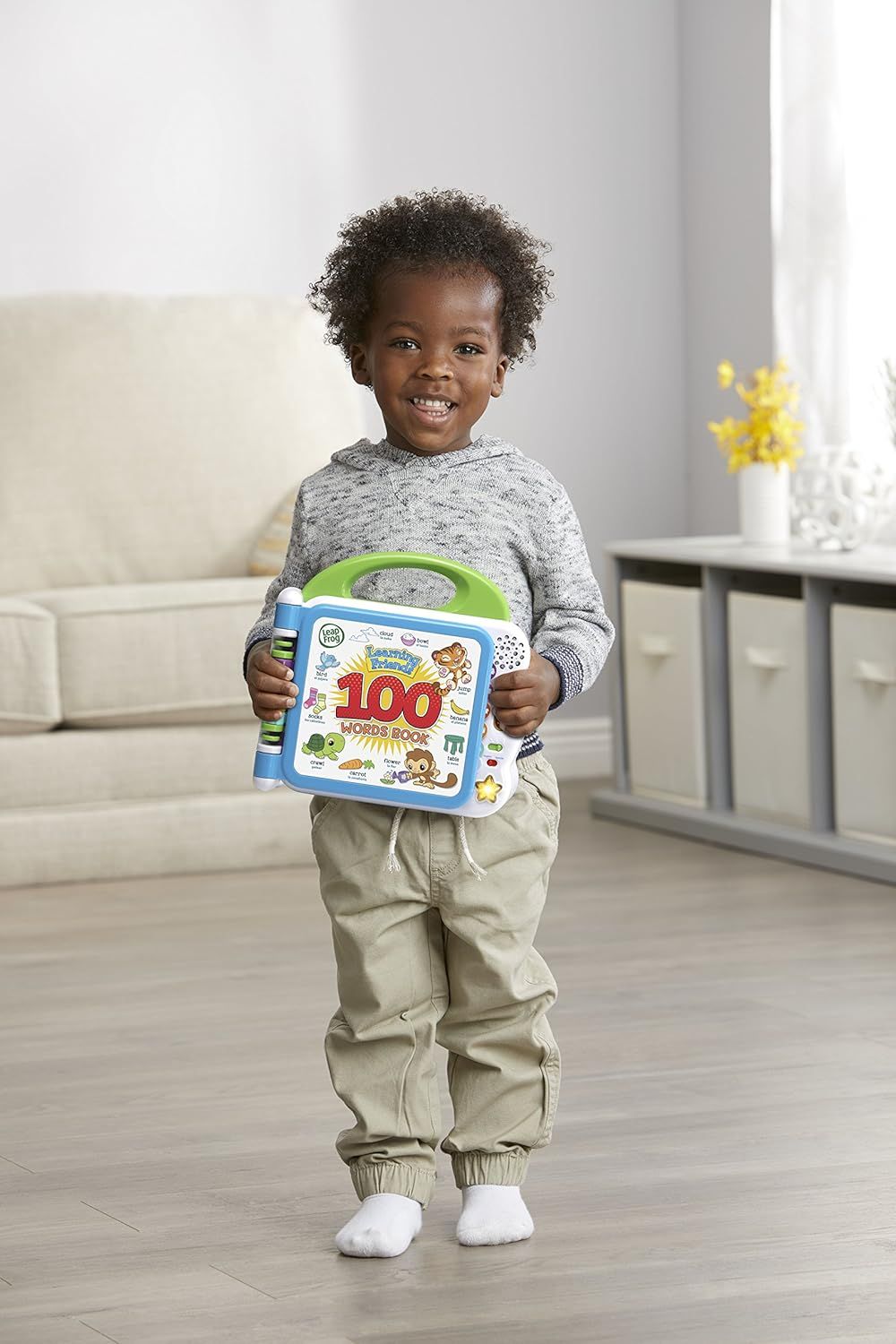 Demonstrates the product in a real-world home setting with a happy child to help shoppers visualize the product in use and connect emotionally with the brand.