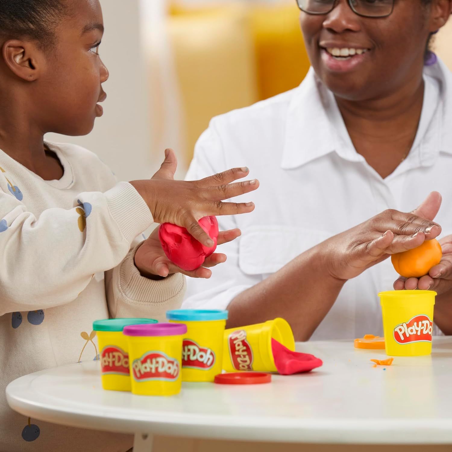 Demonstrates the product being used in a real-world family setting to show how it facilitates creative play and bonding between generations.