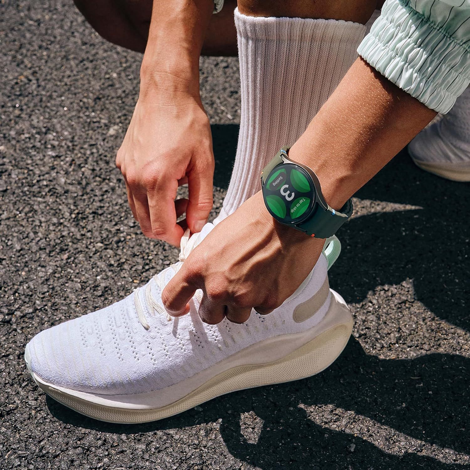 Demonstrates the product in a real-world athletic setting to help shoppers visualize the smartwatch as part of an active lifestyle.