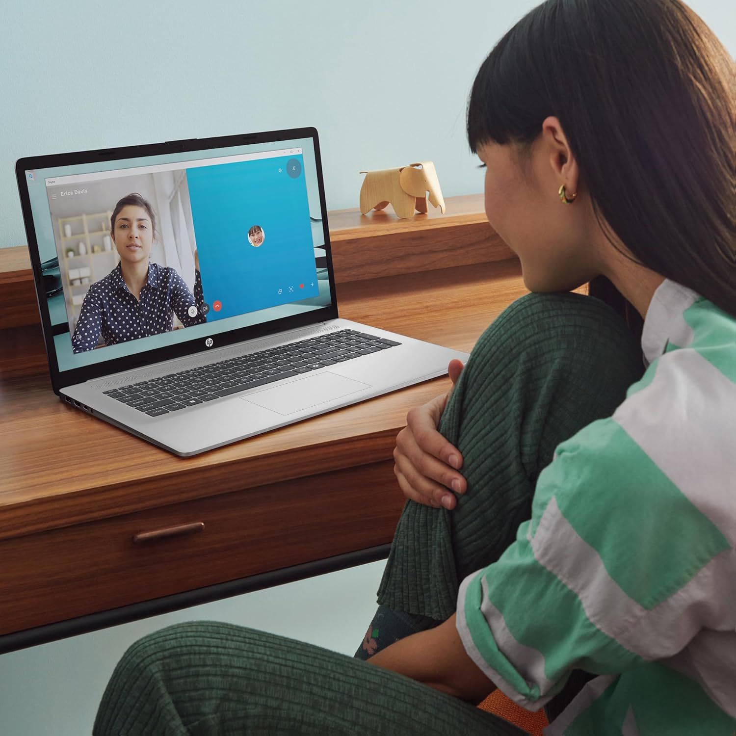 Demonstrates the product in a real-world home office setting, showing how it enables video calls and remote communication in a natural, relatable context.