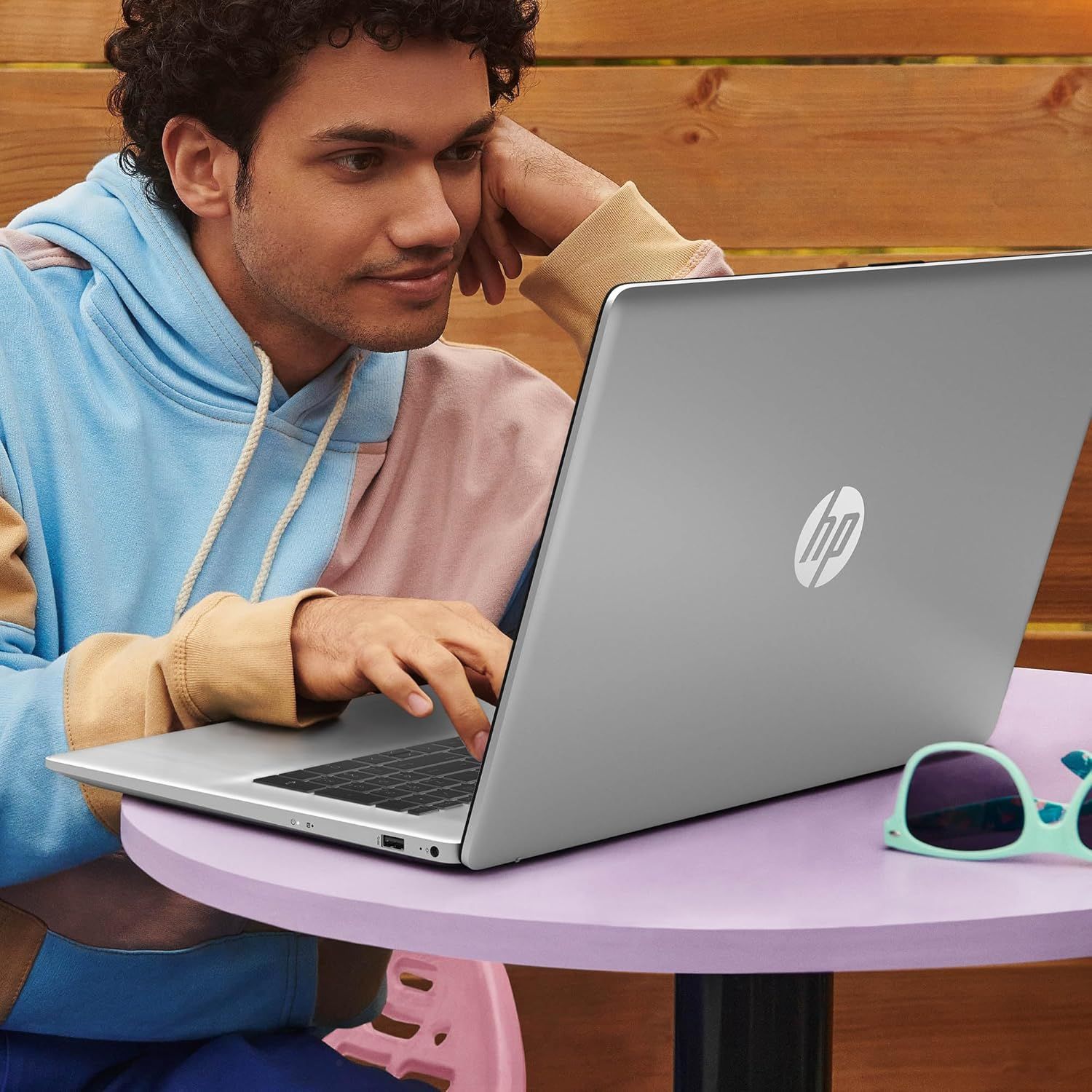 Demonstrates the product in a natural, everyday context to help shoppers visualize using the laptop in their own life, emphasizing portability and casual use.