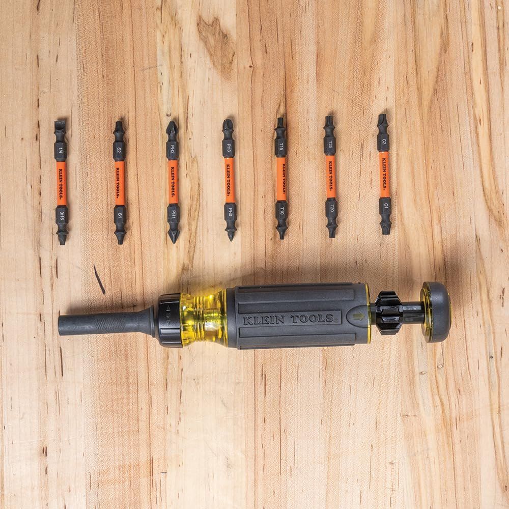 Shows the customer everything included in the purchase: a Klein Tools screwdriver handle with multiple double-ended bits, demonstrating the completeness and value of the kit.