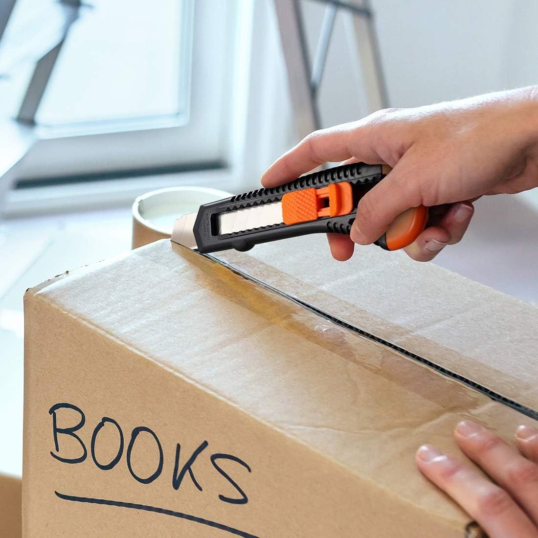 Demonstrates the product being used in a real-world setting (opening a moving box) to help shoppers visualize practical everyday use.