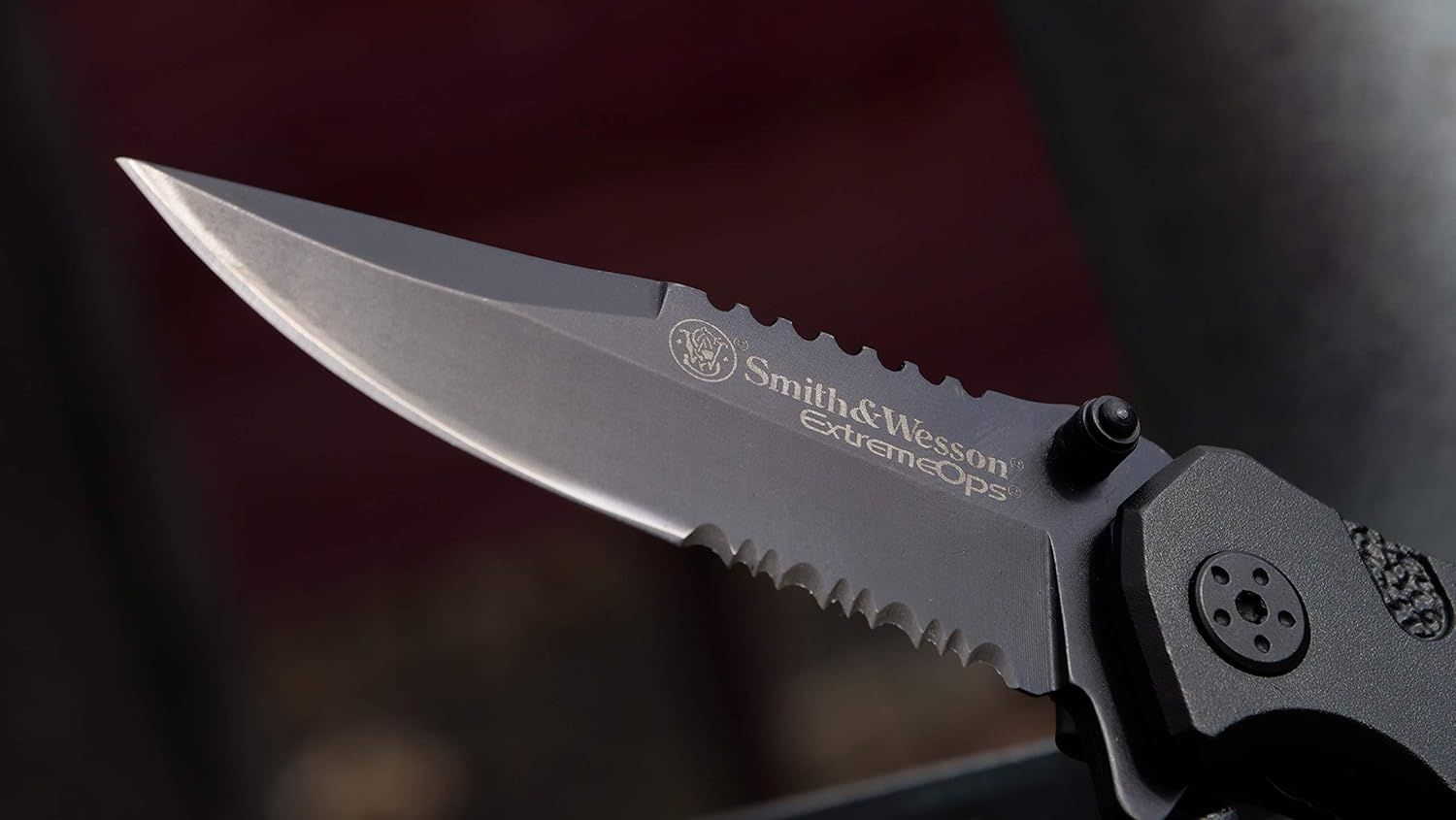 Showcases the Smith & Wesson brand logo and Extreme Ops product line name prominently on the knife blade to build brand recognition and trust with shoppers.