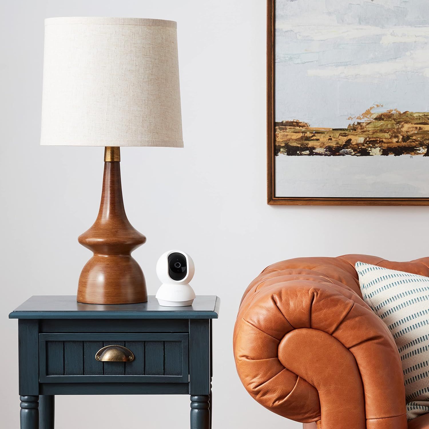Demonstrates how the product (security camera) fits naturally into a stylish home environment, reassuring shoppers that it won't disrupt their interior design aesthetic.