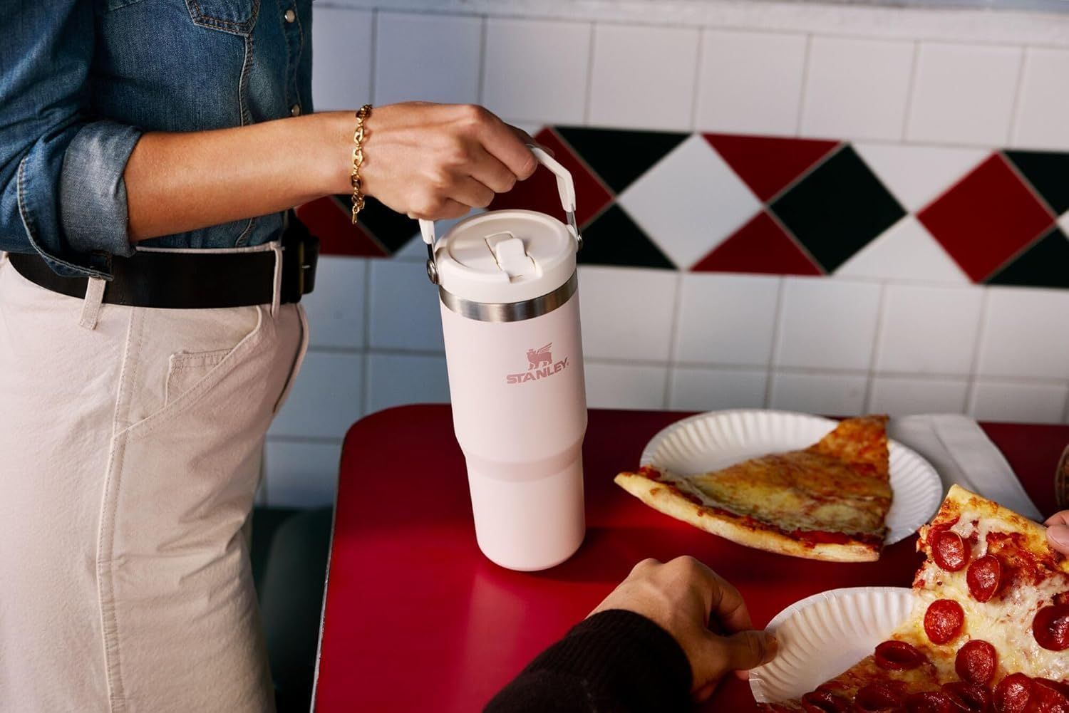 Demonstrates the product in an authentic everyday context to help shoppers visualize using the tumbler in their own life, building emotional connection and relatability.
