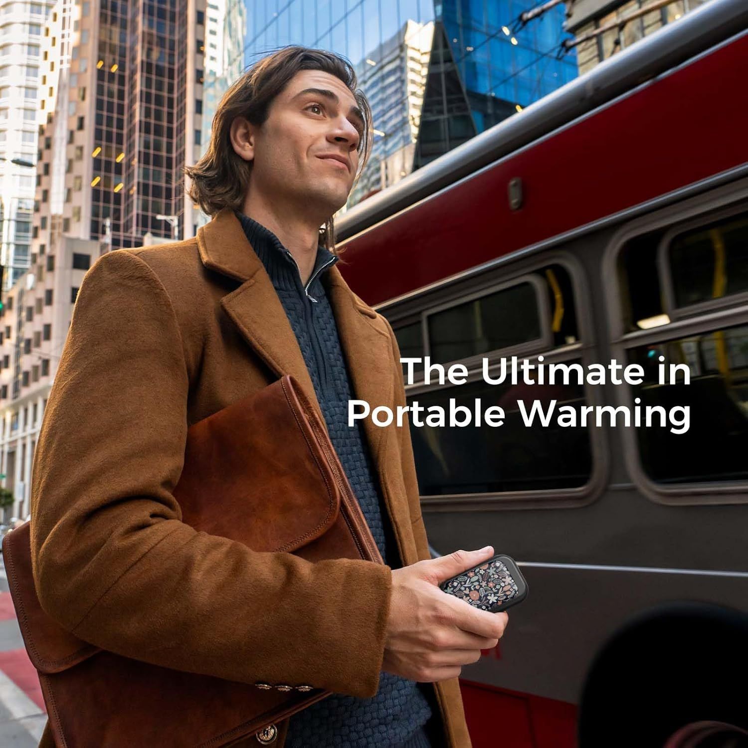 Demonstrates the product in a real-world urban commuting context to show its portability and everyday use case, positioning it as ideal for on-the-go warming.