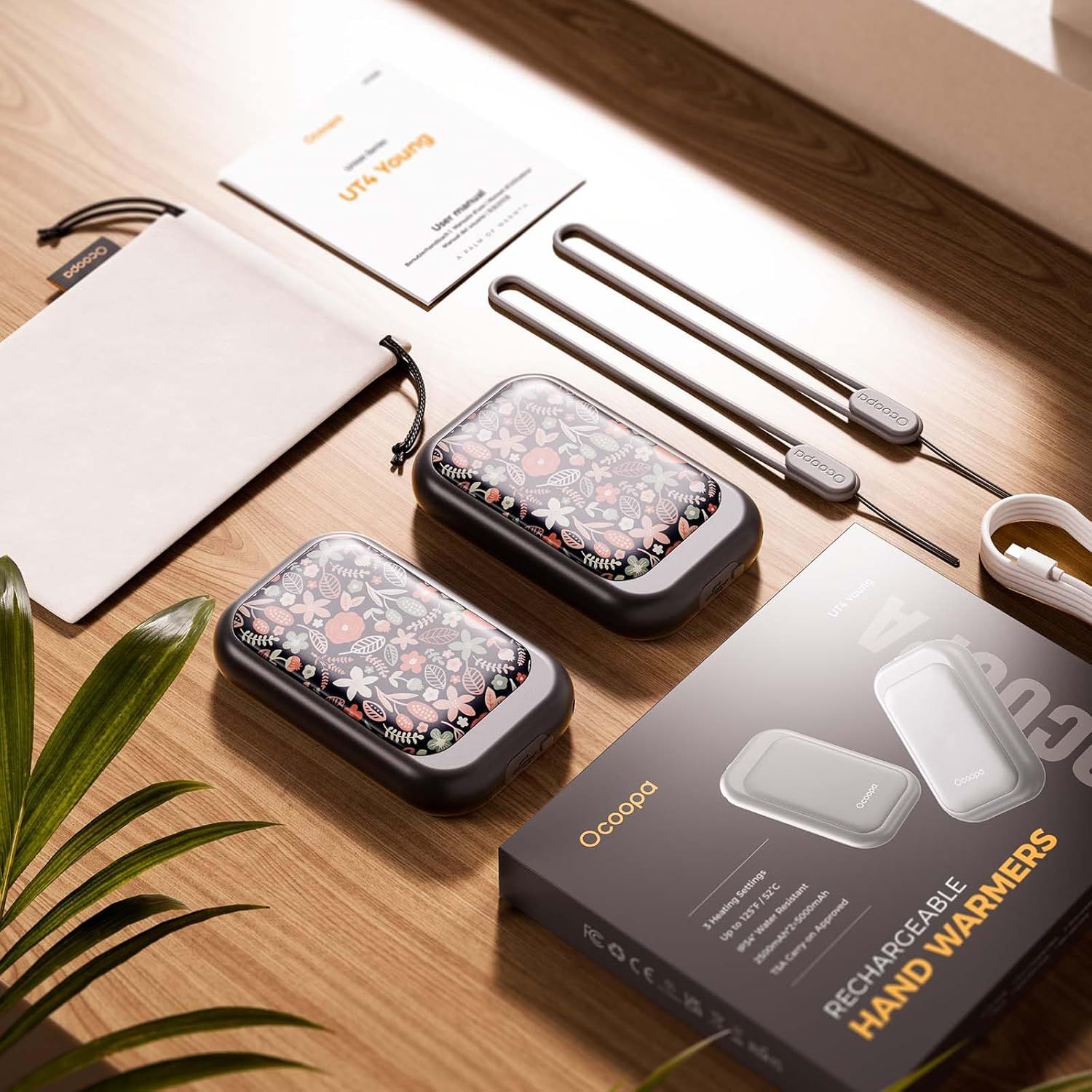 Shows everything included in the purchase to help shoppers understand the full value of the bundle, including the hand warmers, charging cable, storage cases, and documentation.