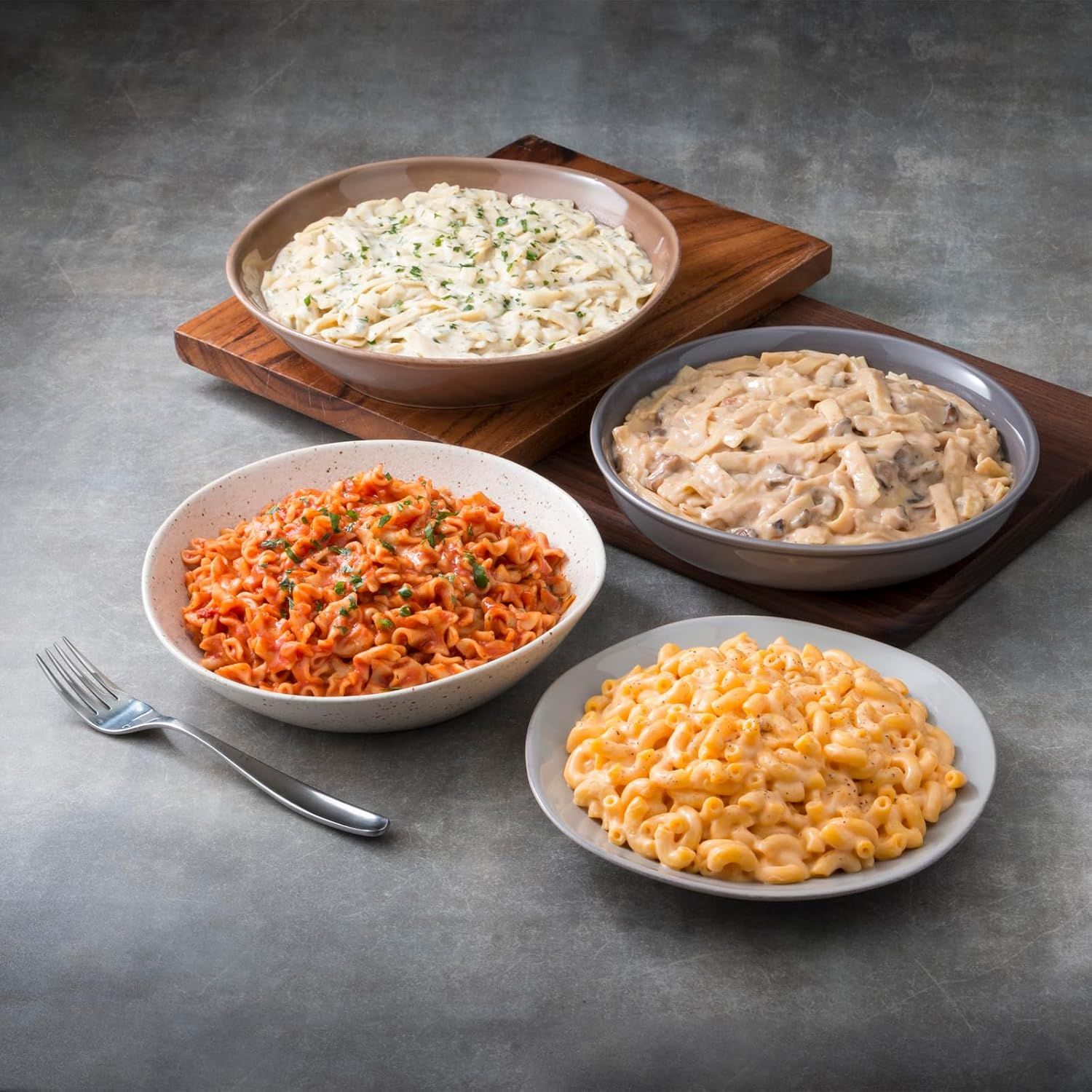 Showcases the brand's product portfolio by displaying multiple pasta varieties side-by-side, helping shoppers understand the range of flavors and options available within the product line.