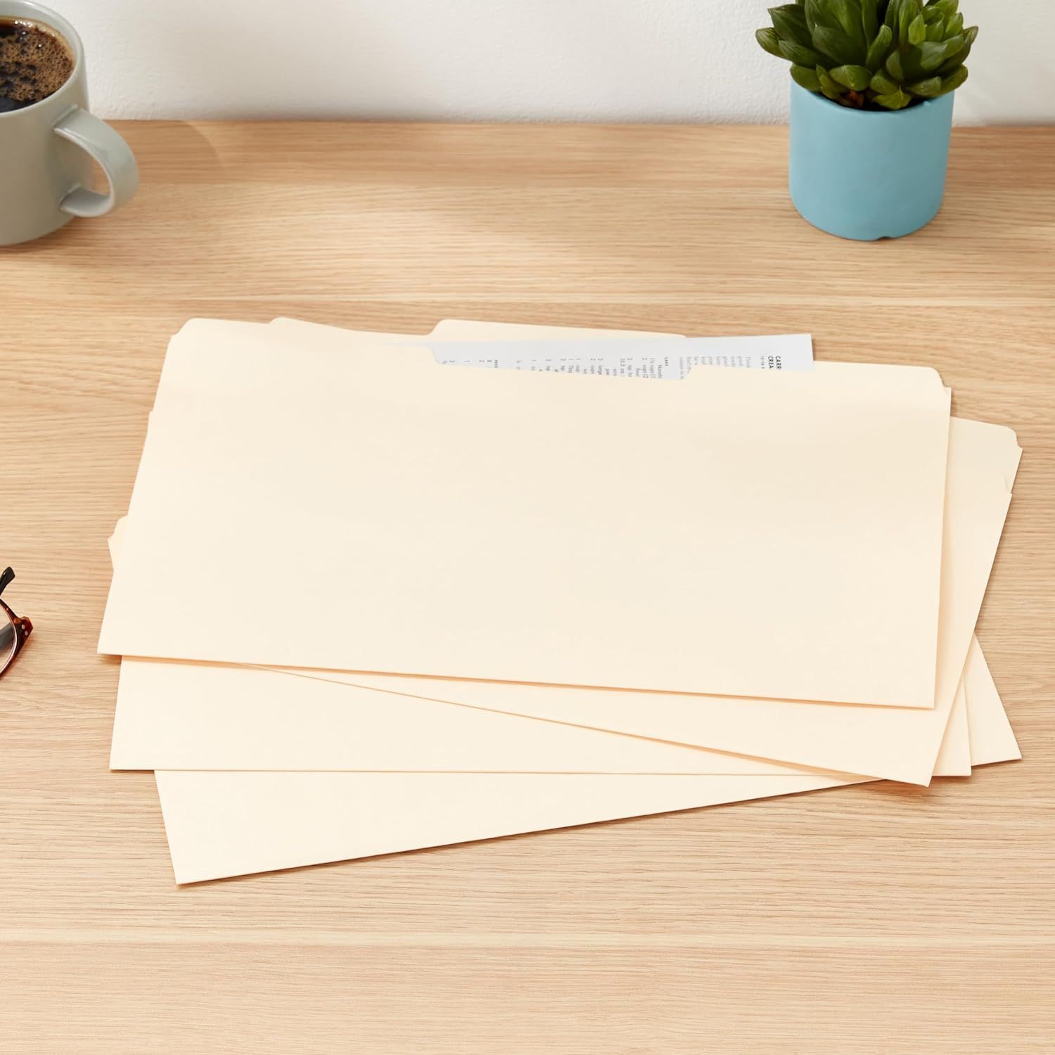 Shows the product (file folders) in a real-world desk setting to help shoppers visualize how they would use and display the folders in their own workspace.