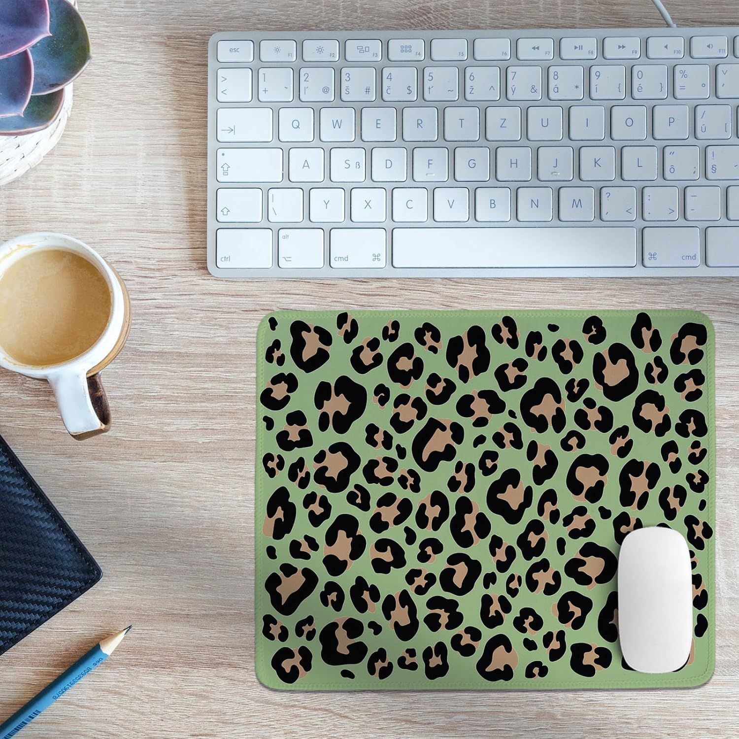 Showcases the product (leopard print mouse pad) in a real-world office/workspace setting to help shoppers visualize how it fits into their daily environment and aesthetic.