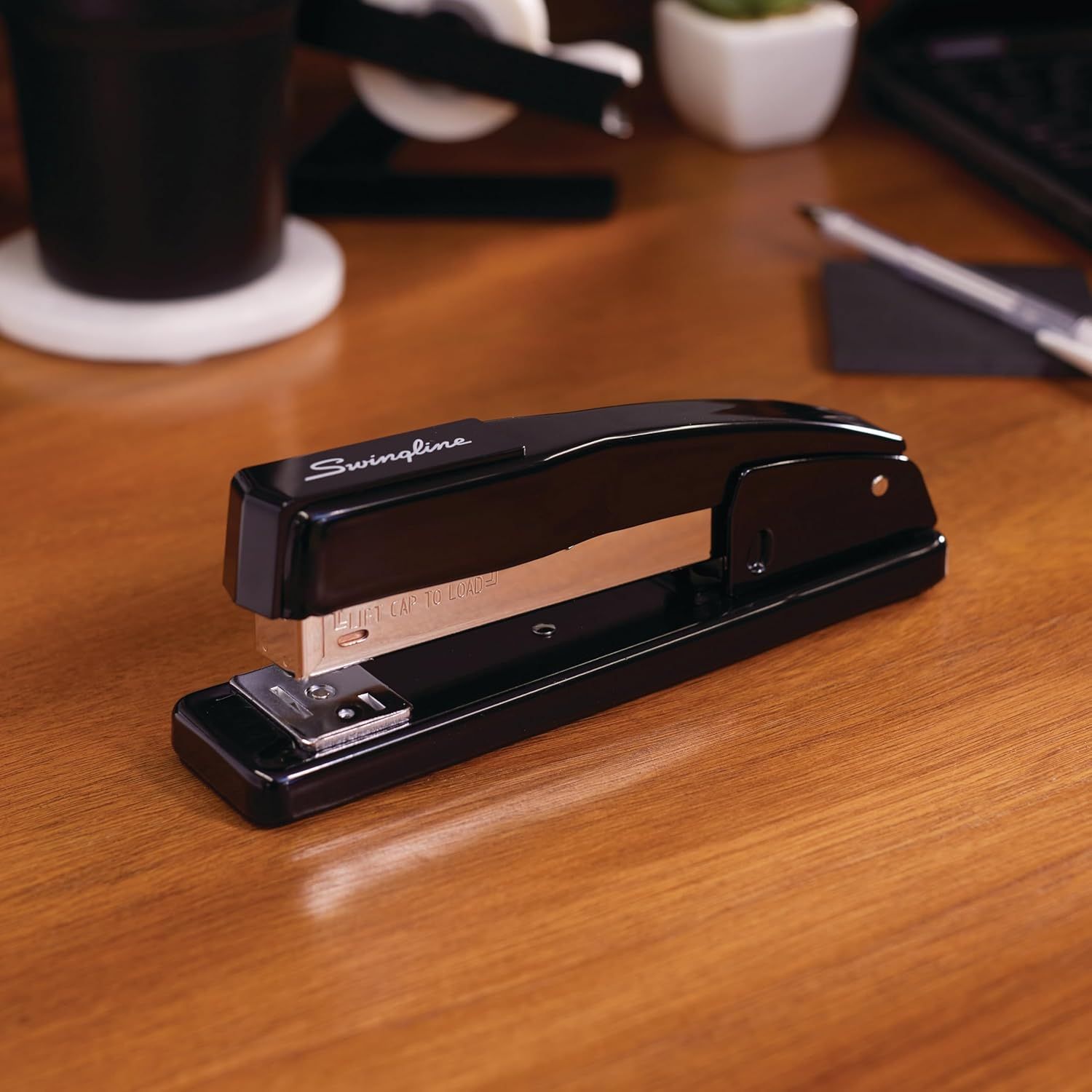 Showcases the stapler in a real-world office setting to help shoppers visualize the product on their own desk and understand its professional aesthetic.
