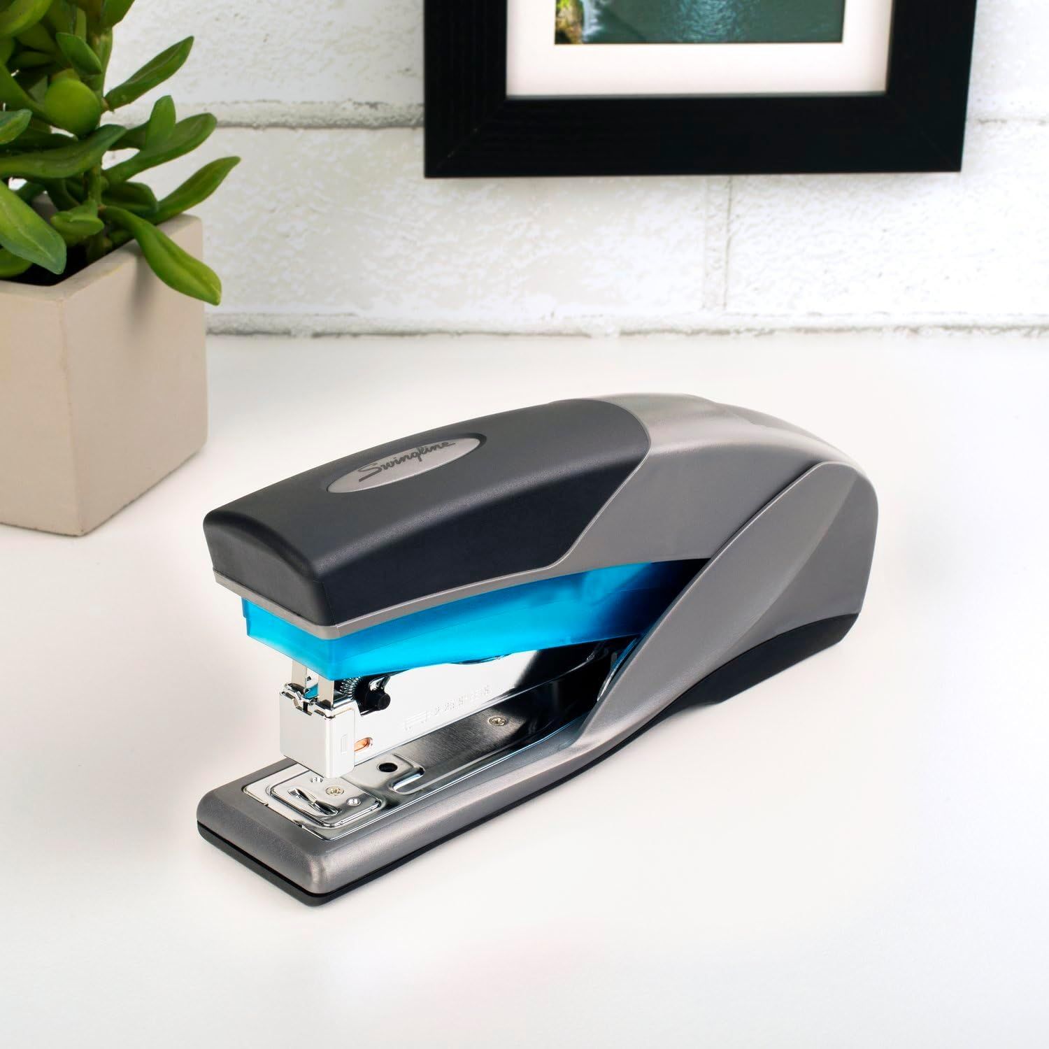 Showcases the stapler in a real-world desktop environment to help shoppers visualize the product in their own workspace.