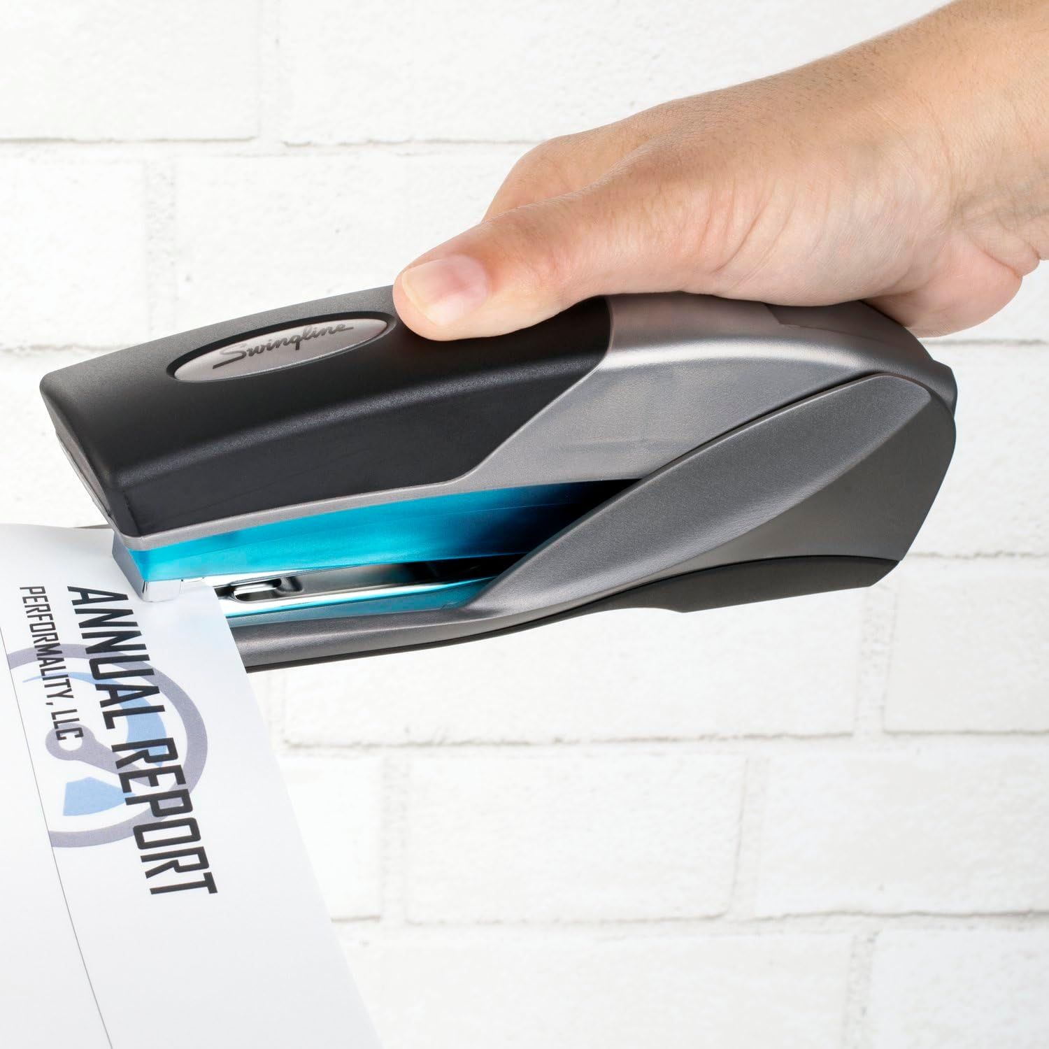 Shows the stapler being used in a real-world context to help shoppers visualize how the product functions and fits into everyday office tasks.