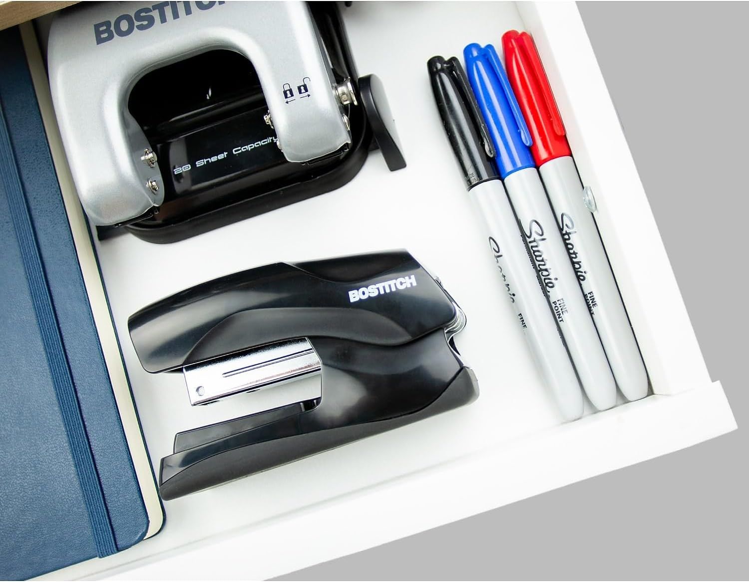 Shows everything included in the package: a stapler, staple remover, and three Sharpie markers, reassuring the shopper they're getting a complete office supply set.