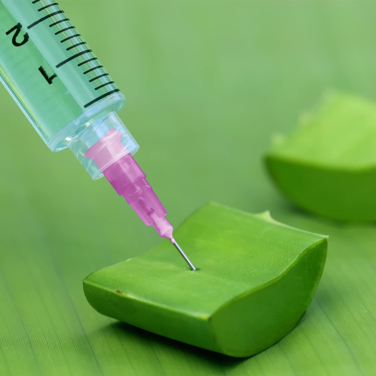 Demonstrates the product being used in a real-world context, showing the syringe with measurement markings dispensing liquid onto a green surface, helping shoppers visualize practical application.
