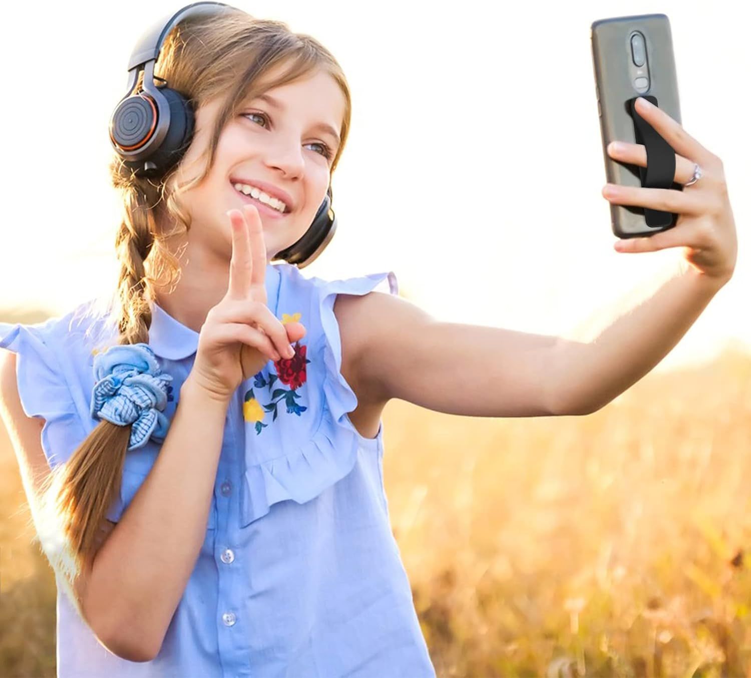 Demonstrates the product (headphones) being used naturally in a real-world outdoor setting to help shoppers visualize everyday use and appeal to younger users.