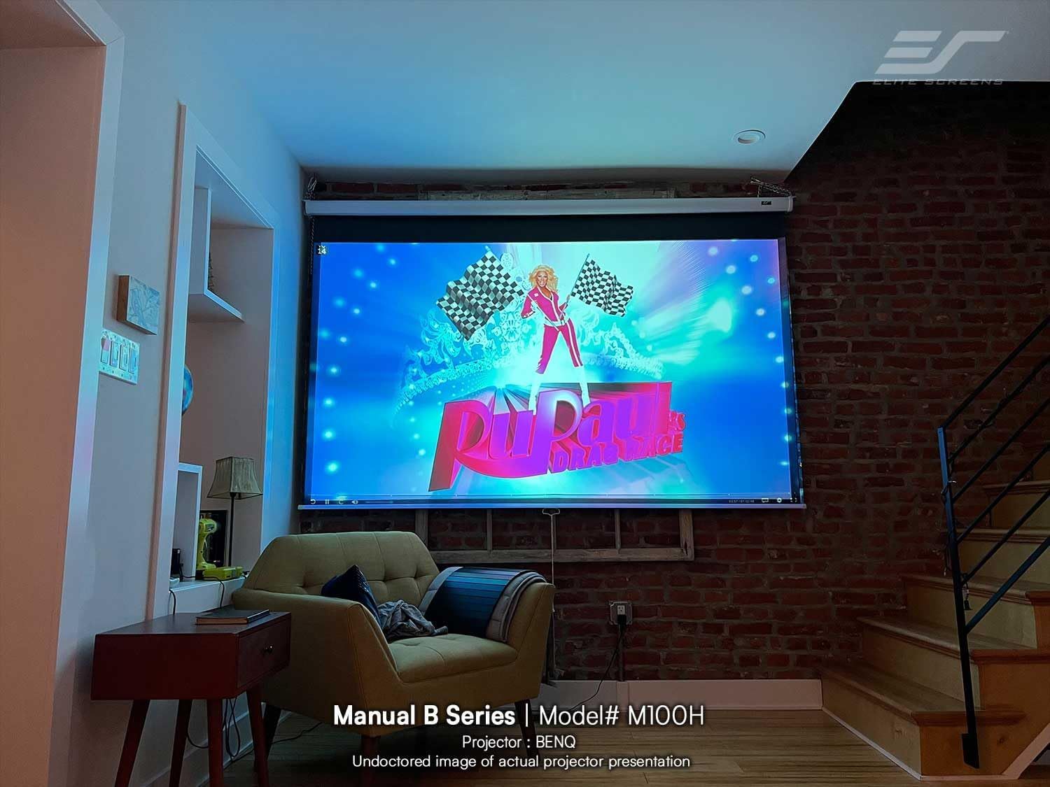 Demonstrates the projector screen installed in a real-world living space to help shoppers visualize how the product looks and functions in an actual home environment.
