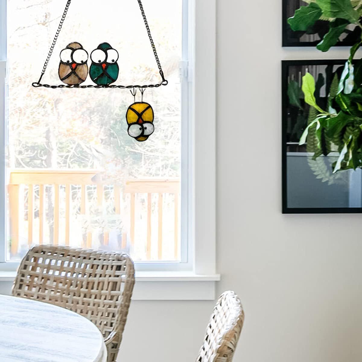 Demonstrates the product as a decorative window hanging in a real home setting to help shoppers visualize how it looks in use.