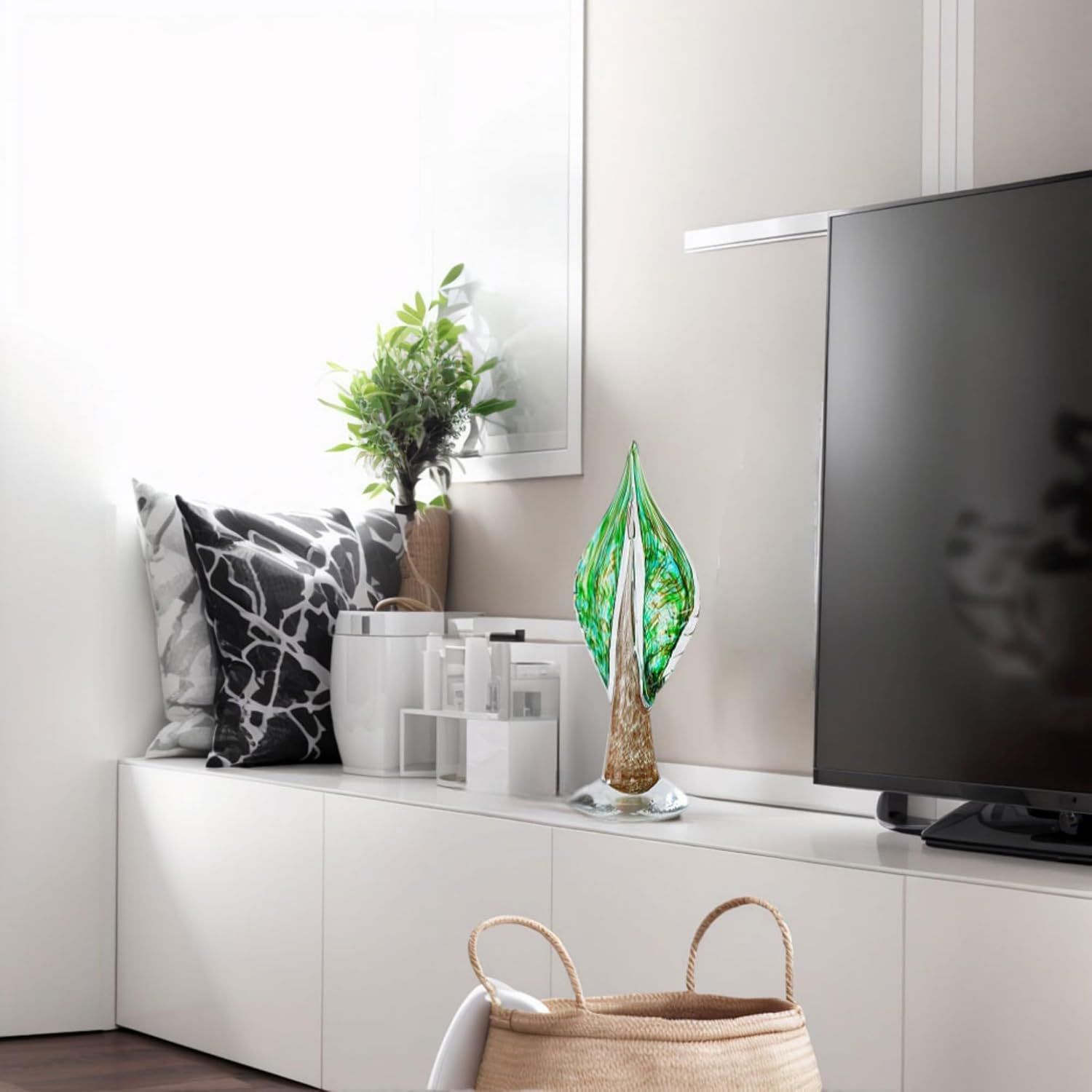 Showcases the product (decorative glass leaf sculpture) in a real-world home setting to help shoppers visualize how it fits into modern interior design.