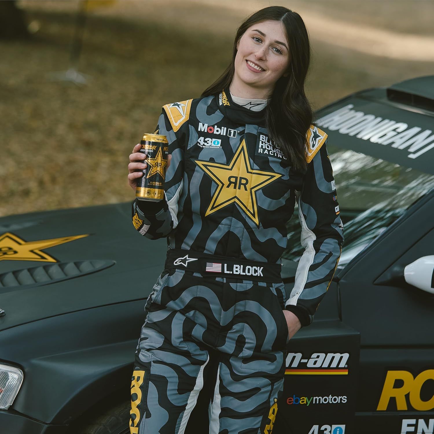 Showcases the product in an authentic racing lifestyle setting to create aspirational appeal and demonstrate real-world use by a professional athlete.