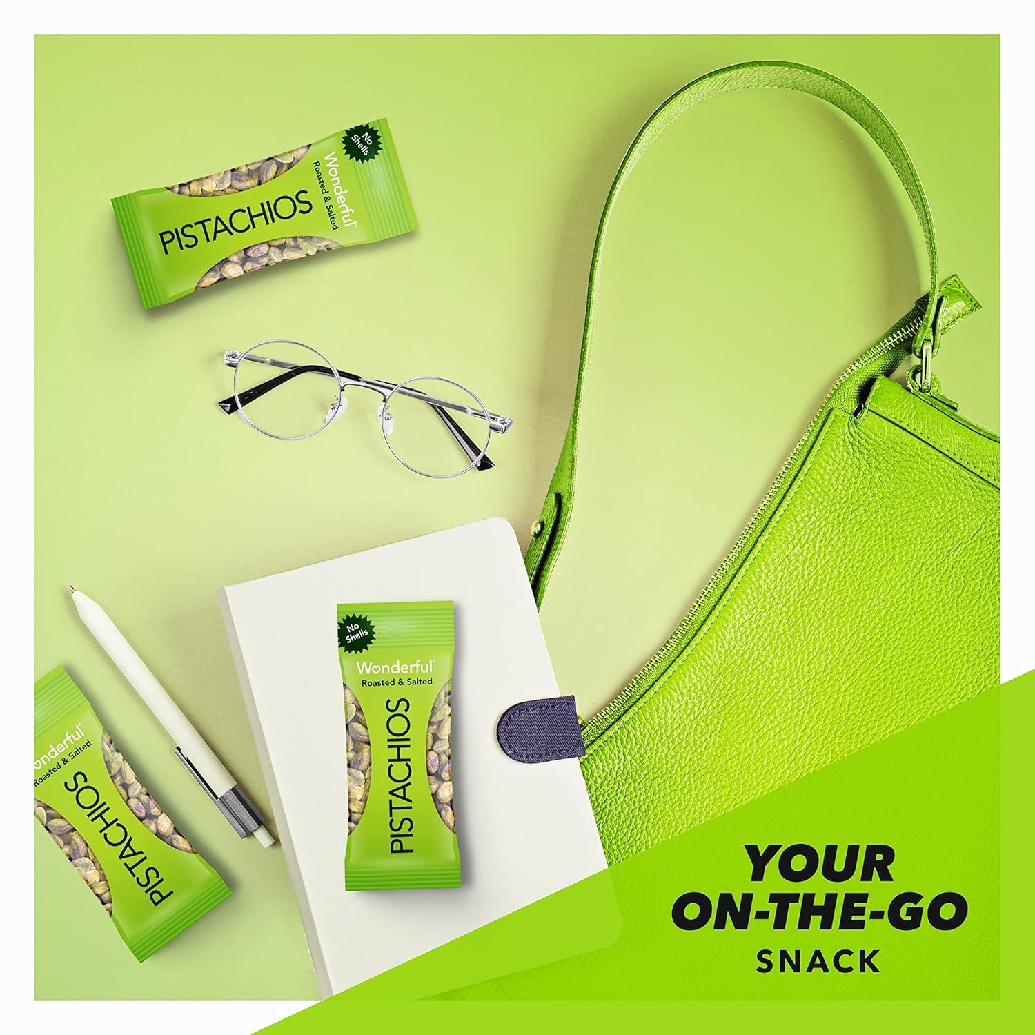 Communicates that the pistachios are a convenient, portable snack perfect for busy, on-the-go lifestyles by showing them alongside everyday carry items.