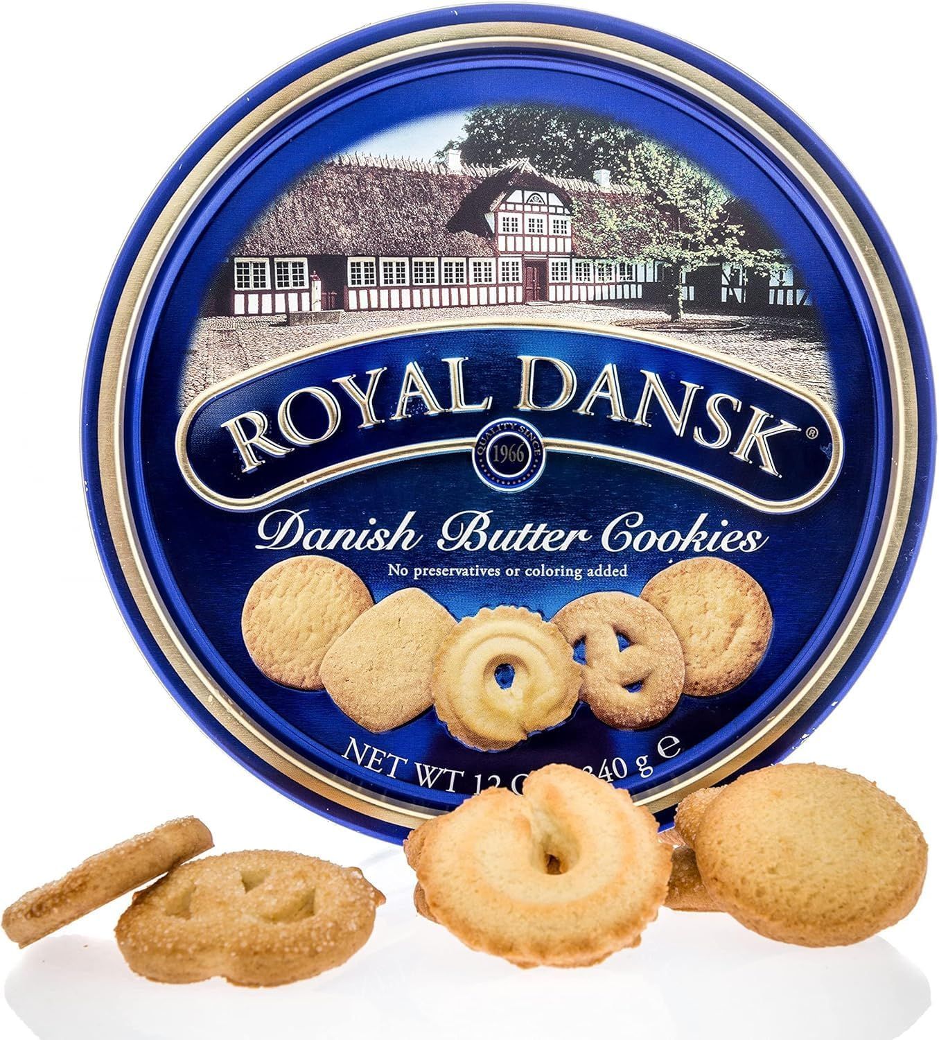 Shows the Royal Dansk Danish Butter Cookies tin packaging with sample cookies displayed in front, allowing shoppers to see both the iconic blue tin and the variety of cookie shapes included.