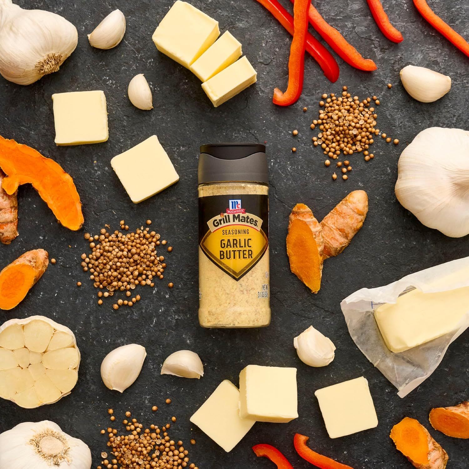 Showcases the product alongside complementary fresh ingredients (garlic, butter, peppers, ginger, spices) to inspire culinary use and demonstrate recipe versatility.