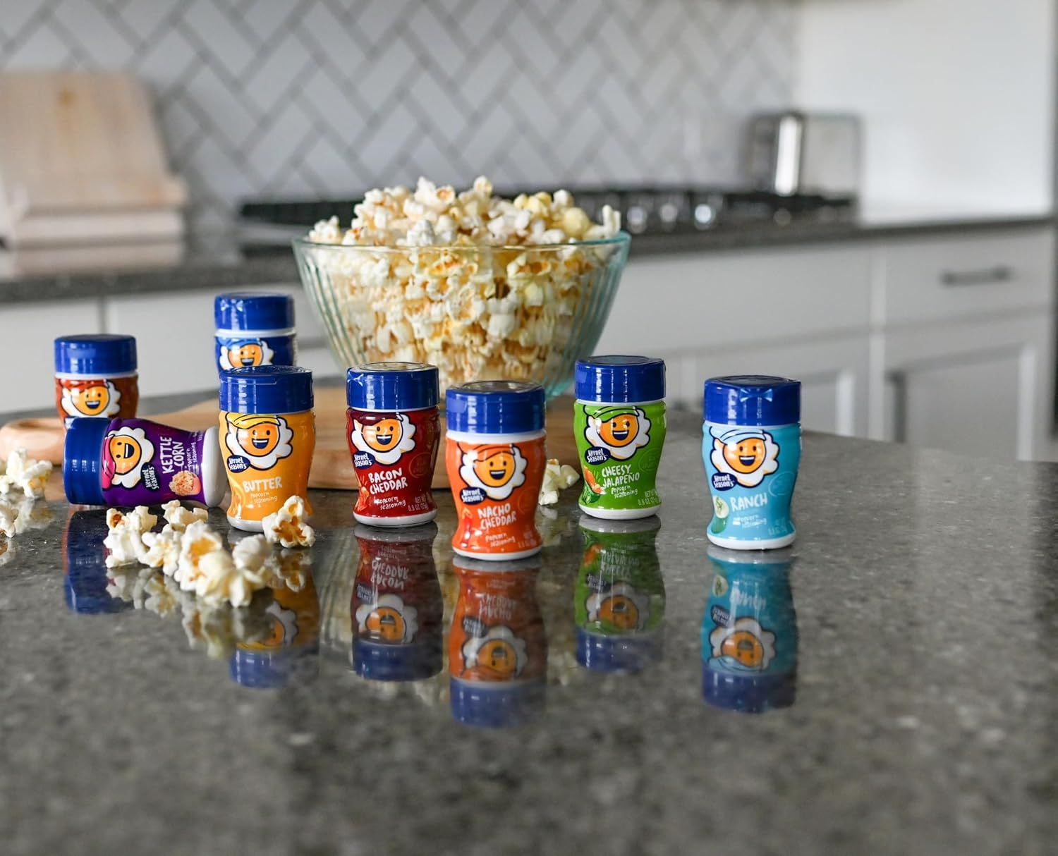 Shows the product line in an authentic home kitchen environment with popcorn to demonstrate real-world usage and create an appealing, relatable context for shoppers.